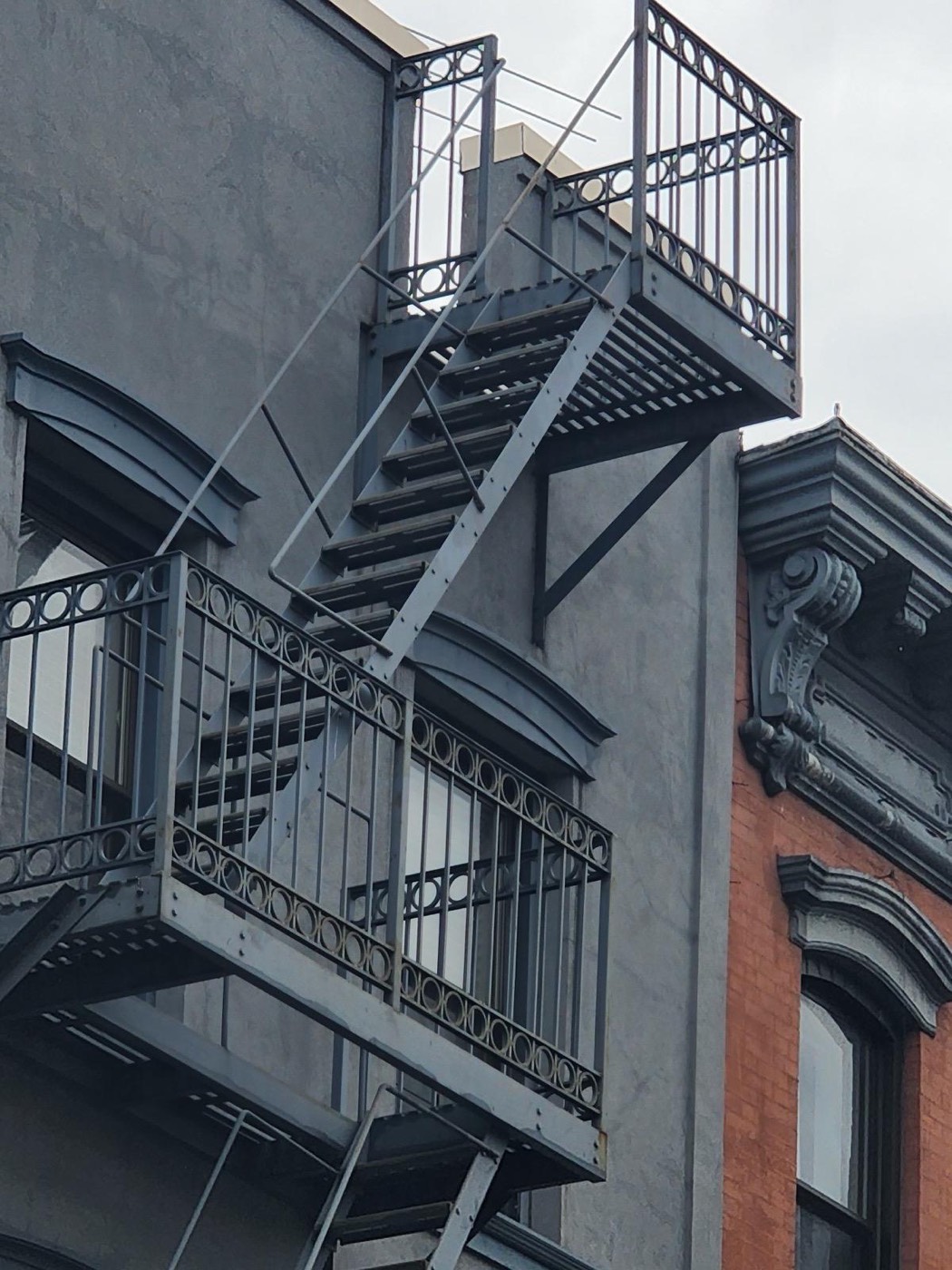 Ornamental iron fire-escape balconies