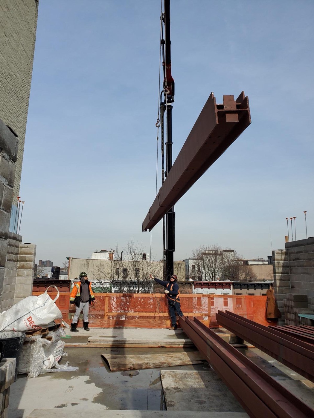 Crane hoisting a steel beam